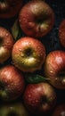 a group of apples with water droplets on them and leaves on the top of them, all in a pile, with a green leaf on top of them