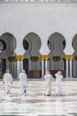 A group of arab men walking towards a mosque taken on April 01, 2013 in Abu Dhabi, United Arab Emirate