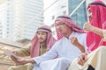 The group of arabian businessman smiling and watching tablet