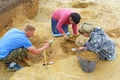 A group of archaeologists unearth burials of the Iron Age