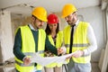 Group of architect watching some details on blueprints at construction site Royalty Free Stock Photo