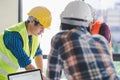 Group of architects look at blueprint and discussing project construction Royalty Free Stock Photo