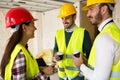 Group of architects talking on coffee break at construction site