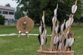 Group of Arrows inside Wicker Basket and Straw Archery Target in Royalty Free Stock Photo