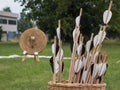 Group of Arrows inside Wicker Basket and Straw Archery Target in Royalty Free Stock Photo