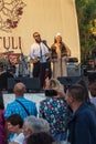 A group of artists from Georgia perform during a free event in an open-air city park.