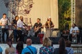 A group of artists from Georgia perform during a free event in an open-air city park.