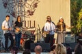 A group of artists from Georgia perform during a free event in an open-air city park.