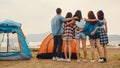 Group of Asia best friends teenagers have fun look at nice sunset view enjoy happy moments together beside camp and tents in Royalty Free Stock Photo