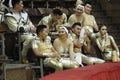 Group of Asian artists sitting on sits in front of arena of the National Kiev circus before giving press-conference