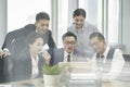 Group of asian business people having a discussion using laptop computer Royalty Free Stock Photo