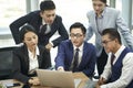 group of asian business people having a discussion using laptop computer Royalty Free Stock Photo