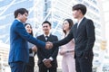 Group of Asian business people shaking hands, finishing up a deal or outdoors meeting. Businessman and businesswoman in formal Royalty Free Stock Photo