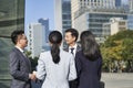 Group of asian business people standing chatting on street in downtown Royalty Free Stock Photo