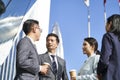 Group of asian business people standing chatting on street in downtown Royalty Free Stock Photo