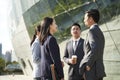 Group of asian business people standing chatting on street Royalty Free Stock Photo