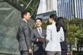 Group of asian business people standing chatting on street Royalty Free Stock Photo