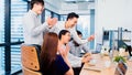 Group of Asian business people work together in team brainstorm discussion, clap hand celebrate in office Royalty Free Stock Photo