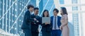 Group asian business team woman and men discuss and meeting,with computer laptop standing in street tower building outside,concept Royalty Free Stock Photo