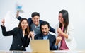 Group of Asian and Caucasian business people wearing formal suits, surprise and very happy with their success on their projects Royalty Free Stock Photo