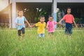 Group of asian children holding hands and running or walking tog Royalty Free Stock Photo