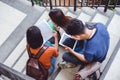 Group of Asian college student using tablet and mobile phone out Royalty Free Stock Photo