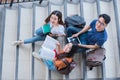 Group of Asian college student using tablet and mobile phone outside classroom. Happiness and Education learning concept. Back to Royalty Free Stock Photo