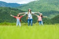 Group asian family children raise arms and standing see mountain outdoors,