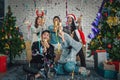 Group of asian friends having fun with confitti at new years or christmas celebration party at home Royalty Free Stock Photo