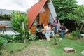 asian friends having fun singing and playing guitar together in the backyard Royalty Free Stock Photo