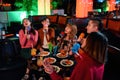 Group of asian friends having fun and singing songs at karaoke club Royalty Free Stock Photo