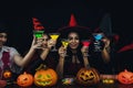 Group of asian friends in spooky costume having fun and drink cocktails at halloween celebration party in nightclub Royalty Free Stock Photo