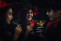 Group of asian friends in spooky costume having fun and drink cocktails at halloween celebration party in nightclub Royalty Free Stock Photo