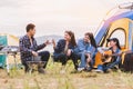 Group of Asian friendship clinking drinking bottle glass for celebrating in private party with mountain and lake view background. Royalty Free Stock Photo