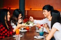 Group of Asian happy and smiling young man and women having a meal together with enjoyment and happiness. Royalty Free Stock Photo