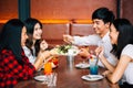 Group of Asian happy and smiling young man and women having a meal together with enjoyment and happiness. Royalty Free Stock Photo