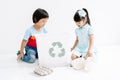 Group of Asian kids school sorting garbage and picking up the garbage and putting it in recycling bin in classroom. Recycling and Royalty Free Stock Photo