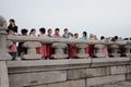 Group of Asian kids in traditional South Korean costumes on a school trip on a cloudy day