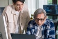 Group of asian senior in a collaborative software development analyzing flowcharts during a bootcamp training