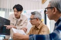 Group of asian senior in a collaborative software development analyzing flowcharts during a bootcamp training