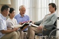 group of senior asian people reading bible together