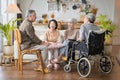 Group Asian seniors friends are sitting in the living room of a home together, enjoying talking together. Royalty Free Stock Photo