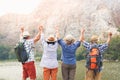 A group of Asian elders standing on high mountains enjoying nature