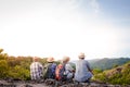 An elderly group of Asian people climbing and standing on high mountains enjoying nature