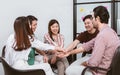 Group of Asian teamwork businesspeople making high five with togetherness or tag their hands with happiness and confidence after