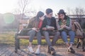 Group of Asian teenage students schoolchildren sitting on a bench in the park and preparing exams Royalty Free Stock Photo