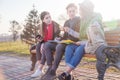 Group of Asian teenage students schoolchildren sitting on a bench in the park and preparing exams Royalty Free Stock Photo