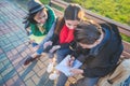 Group of Asian teenage students schoolchildren sitting on a bench in the park and preparing exams Royalty Free Stock Photo