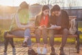 Group of Asian teenage students schoolchildren sitting on a bench in the park and preparing exams Royalty Free Stock Photo