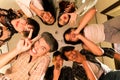 a group of Asian teenagers forming a circle and looking down with funny faces in an old room Royalty Free Stock Photo